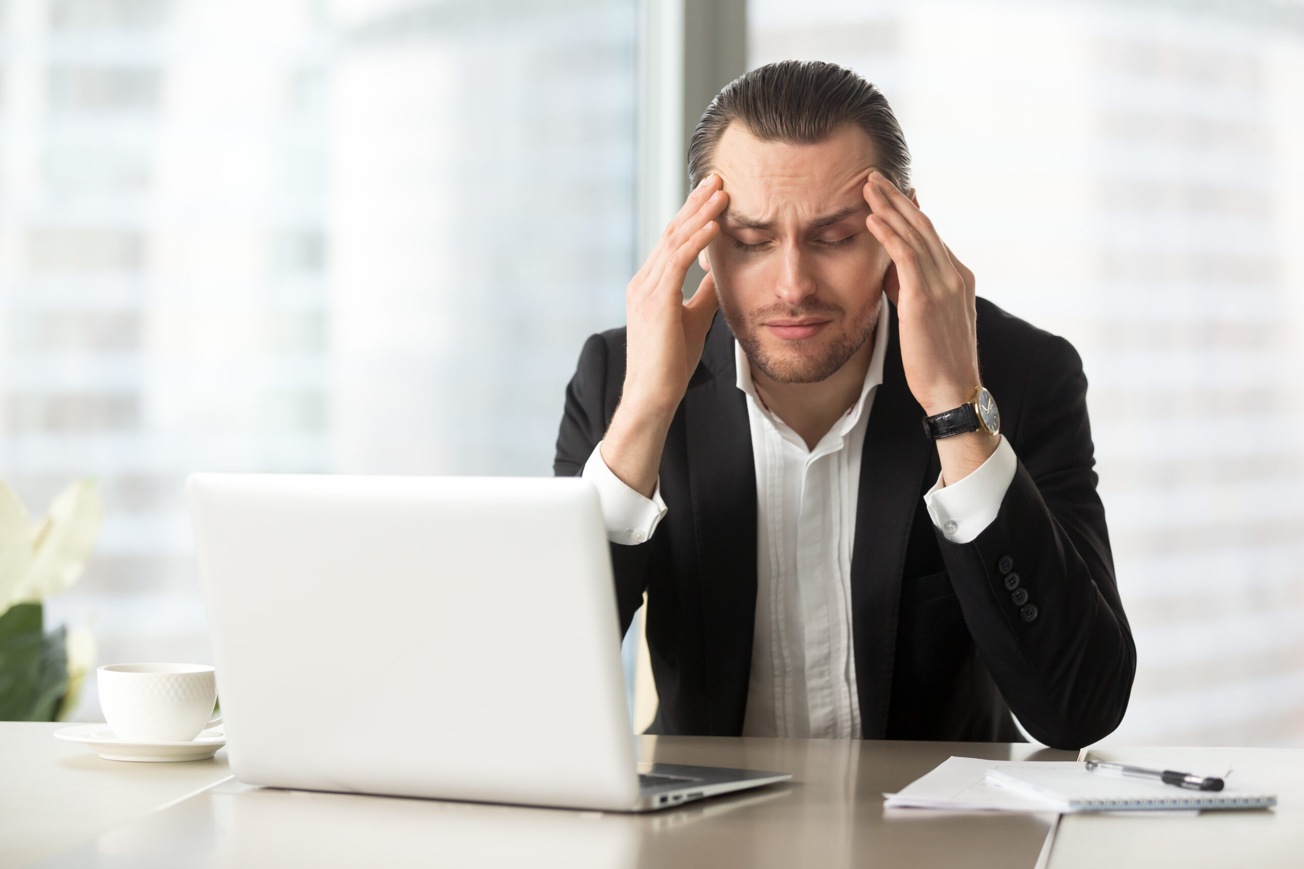 Success Stories 3 tired businessman suffering from headache scaled