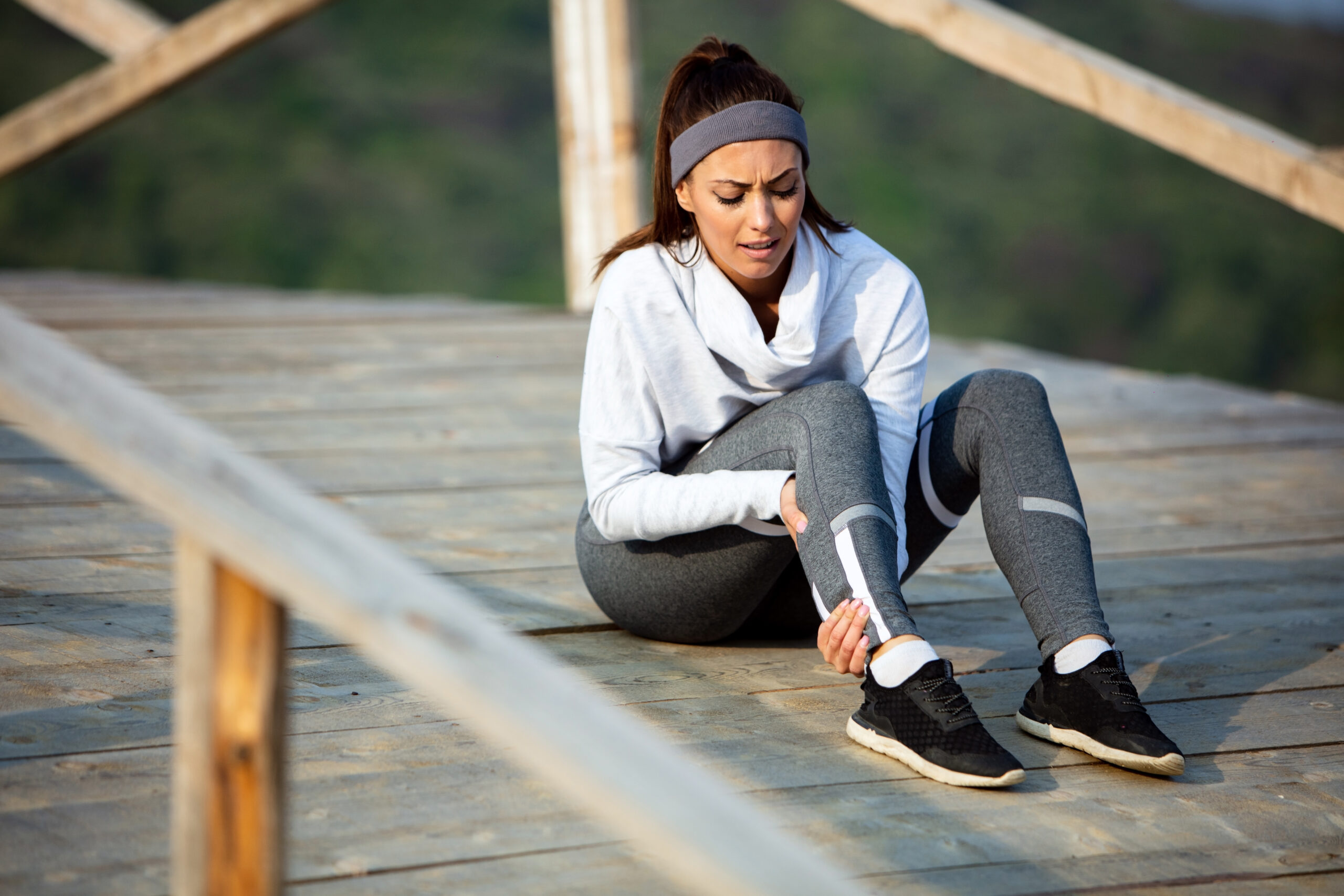 Success Stories 4 young sportswoman experiencing pain her leg while having sports training nature scaled